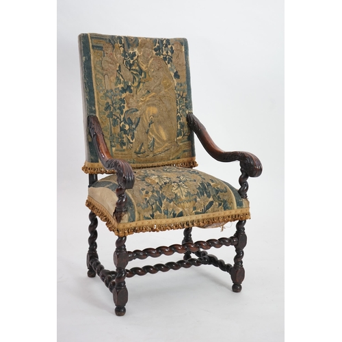 60 - A 17th century French walnut fauteuil with verdure tapestry upholstery, the back depicting a mother ... 