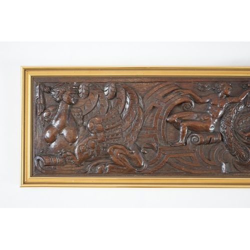 63 - A 17th century oak panel carved with a central cartouche of a reclining bearded man holding a branch... 