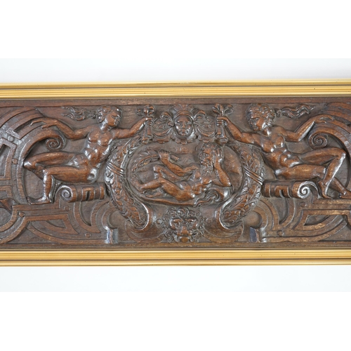 63 - A 17th century oak panel carved with a central cartouche of a reclining bearded man holding a branch... 