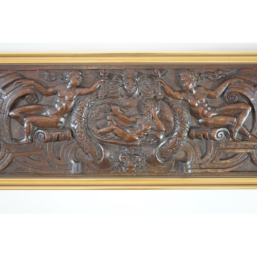 63 - A 17th century oak panel carved with a central cartouche of a reclining bearded man holding a branch... 