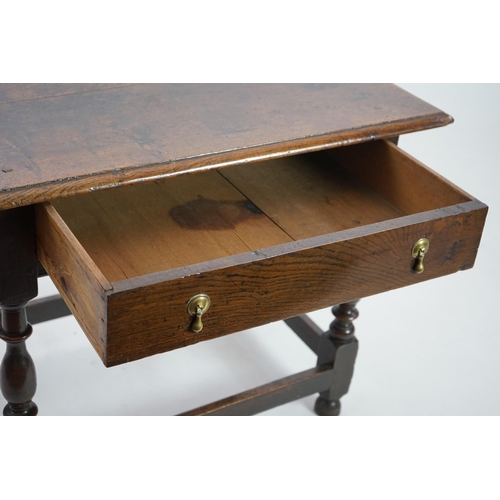 64 - An early 18th century and later oak side table with moulded rectangular top over a frieze drawer, on... 