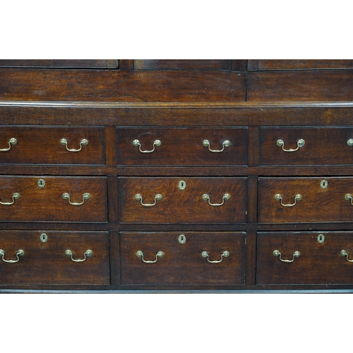 7 - A mid 18th century oak press cupboard with moulded cornice and three panelled doors over three dummy... 