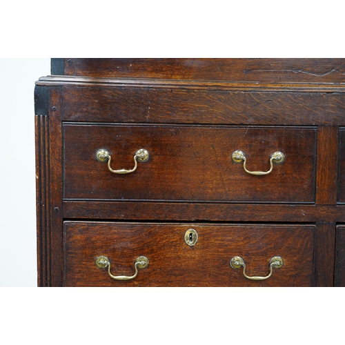 7 - A mid 18th century oak press cupboard with moulded cornice and three panelled doors over three dummy... 