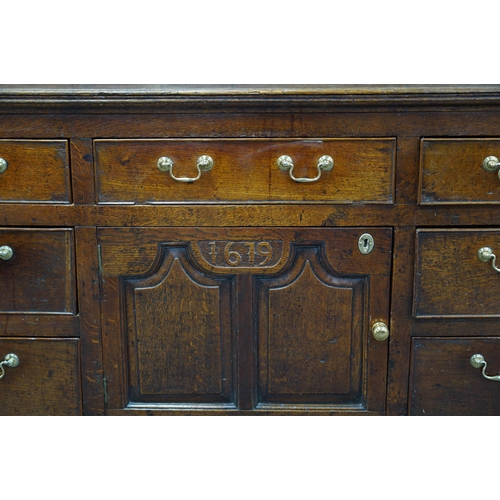 9 - A George III oak dresser base, the raised back with six crossbanded drawers over three frieze drawer... 