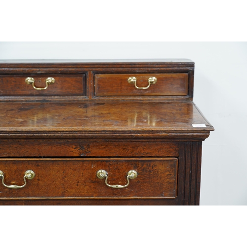 9 - A George III oak dresser base, the raised back with six crossbanded drawers over three frieze drawer... 