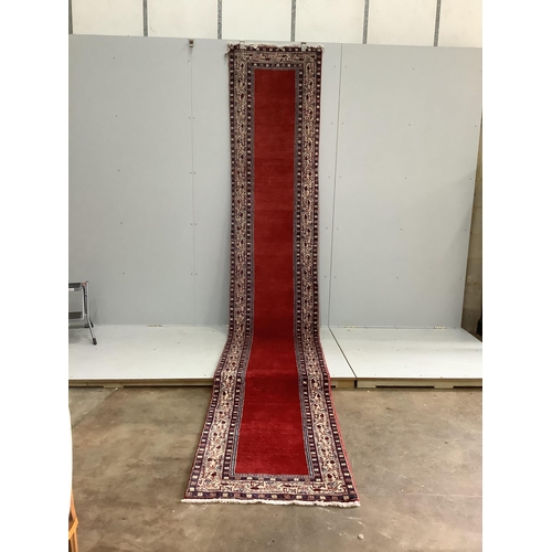 106 - An Araak red ground runner, 440 x 76cm. Condition - fair to good