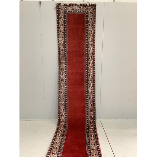 106 - An Araak red ground runner, 440 x 76cm. Condition - fair to good