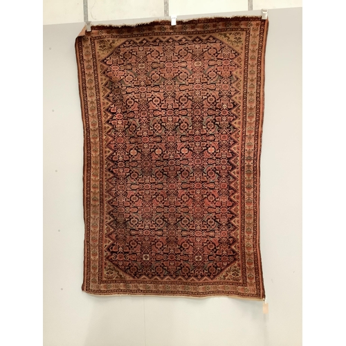 111 - A Caucasian red ground rug, 192 x 129cm. Condition - faded and worn