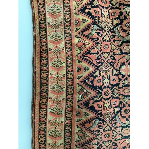 111 - A Caucasian red ground rug, 192 x 129cm. Condition - faded and worn