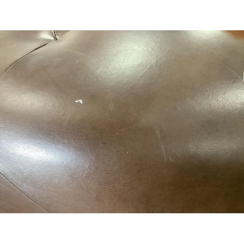 A circular brown leather footstool, diameter 100cm, height 36cm