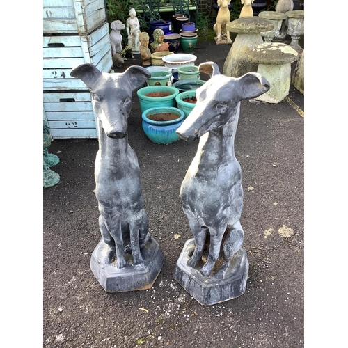 32 - A pair of black painted cast iron models of seated hounds, height 91cm. Condition - weathered