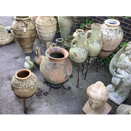 42 - Five earthenware amphora on wrought iron stands, largest height 80cm. Condition - poor to fair... 