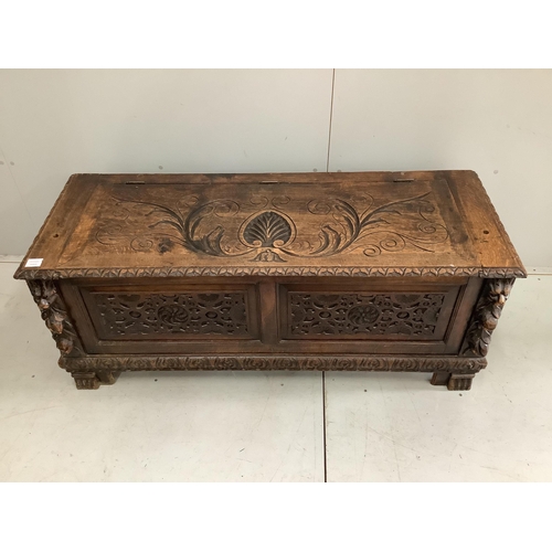 69 - An early 20th century carved oak coffer formerly a monk's bench, width 137cm. Condition - lacking or... 