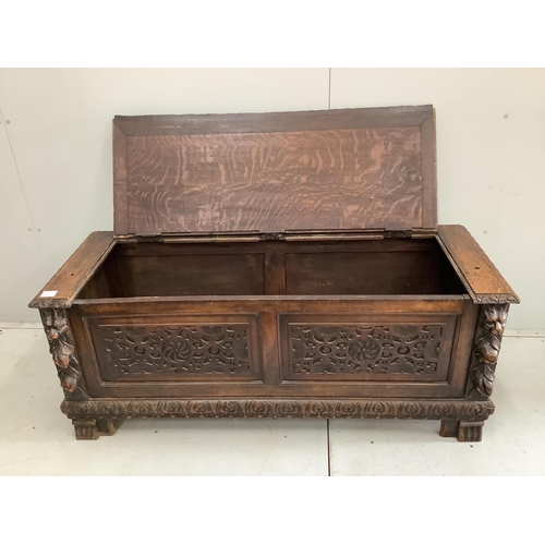 69 - An early 20th century carved oak coffer formerly a monk's bench, width 137cm. Condition - lacking or... 