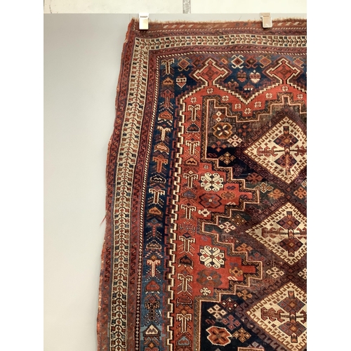 81 - A Caucasian red ground rug, 150 x 118cm. Condition - worn in centre and a little faded, further wear... 