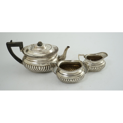 100 - A late Victorian demi-fluted silver three piece tea set, by Horace Woodward & Co Ltd, of oval form, ... 