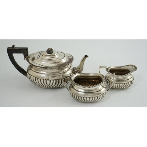 100 - A late Victorian demi-fluted silver three piece tea set, by Horace Woodward & Co Ltd, of oval form, ... 