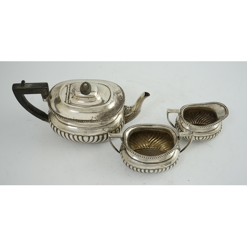 100 - A late Victorian demi-fluted silver three piece tea set, by Horace Woodward & Co Ltd, of oval form, ... 