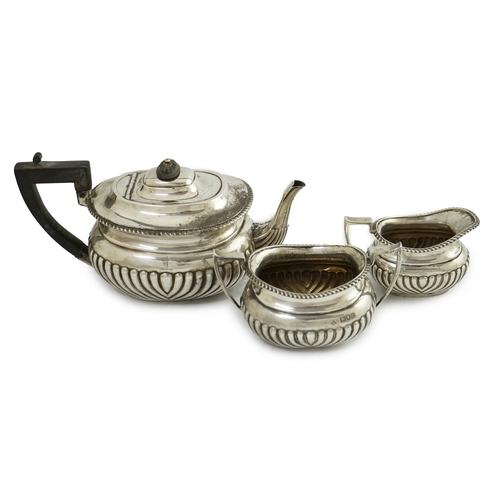 100 - A late Victorian demi-fluted silver three piece tea set, by Horace Woodward & Co Ltd, of oval form, ... 