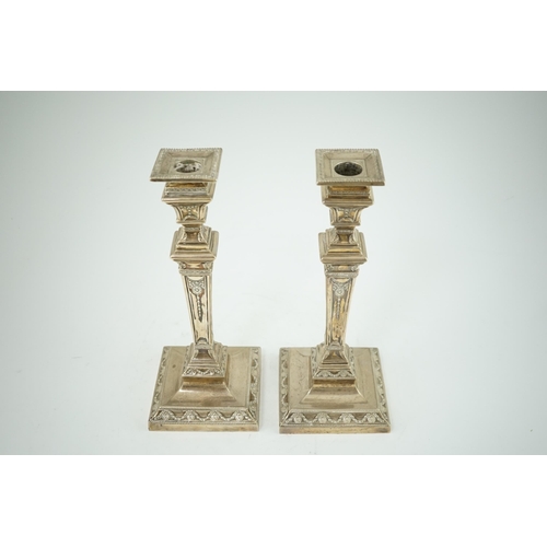 106 - A pair of Edwardian Adam revival silver candlesticks, by Walker & Hall, with beaded borders, on squa... 