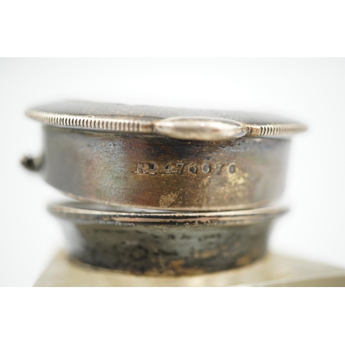 120 - An Edwardian silver watch mounted glass inkwell, maker's mark rubbed, of shaped rectangular form, wi... 