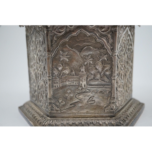 121 - An early 20th century Indian embossed silver hexagonal box with fluted domed hinged cover, decorated... 