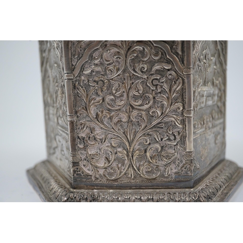 121 - An early 20th century Indian embossed silver hexagonal box with fluted domed hinged cover, decorated... 