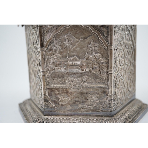 121 - An early 20th century Indian embossed silver hexagonal box with fluted domed hinged cover, decorated... 