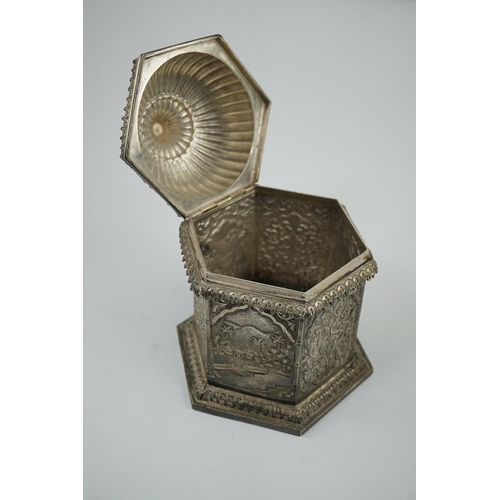 121 - An early 20th century Indian embossed silver hexagonal box with fluted domed hinged cover, decorated... 