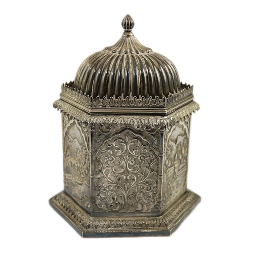 121 - An early 20th century Indian embossed silver hexagonal box with fluted domed hinged cover, decorated... 