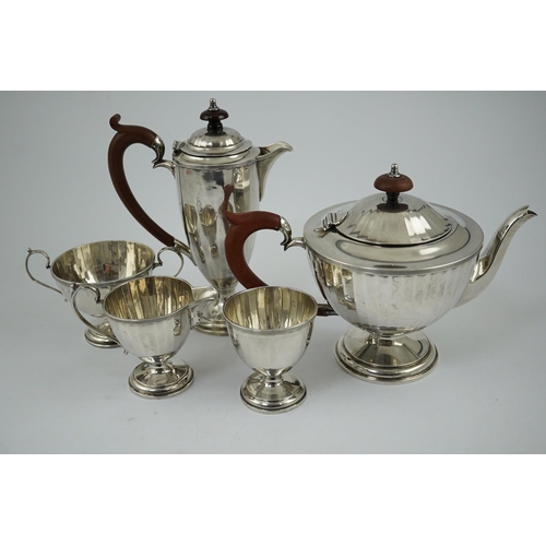 125 - A George V panelled silver five piece tea set by Adie Brothers, of circular pedestal form, Birmingha... 