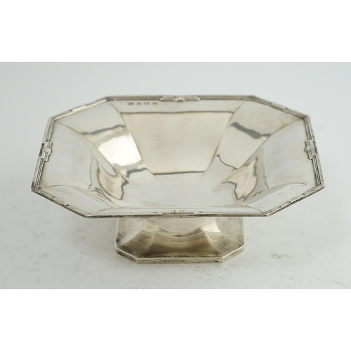 128 - A George V Art Deco silver pedestal fruit bowl, by Elkington & Co, of square form, with canted corne... 