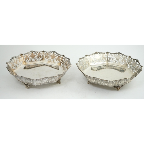 133 - A pair of George VI pierced silver shallow circular fruit bowls, by Mappin & Webb, with leaf decorat... 