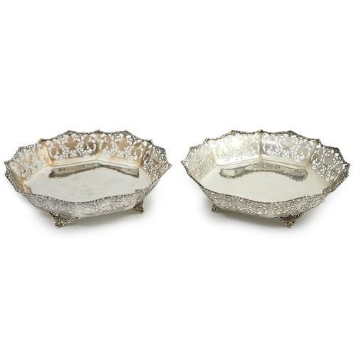 133 - A pair of George VI pierced silver shallow circular fruit bowls, by Mappin & Webb, with leaf decorat... 