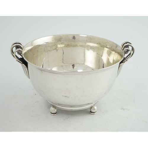 135 - A stylish 1930's Danish silver two handled fruit bowl, by Matthiasen, dated for 1930, on four ball a... 