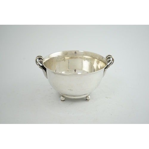 135 - A stylish 1930's Danish silver two handled fruit bowl, by Matthiasen, dated for 1930, on four ball a... 