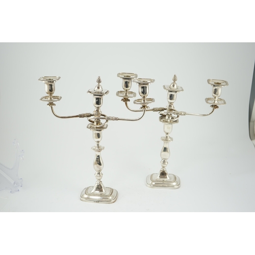 143 - A pair of Elizabeth II silver two branch two light candelabra, by James Dixon & Sons, with scroll ar... 