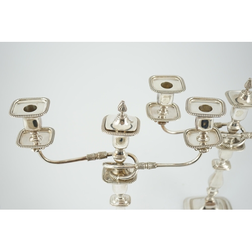 143 - A pair of Elizabeth II silver two branch two light candelabra, by James Dixon & Sons, with scroll ar... 