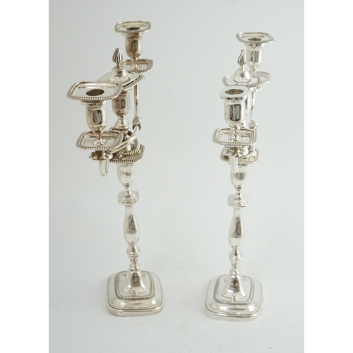 143 - A pair of Elizabeth II silver two branch two light candelabra, by James Dixon & Sons, with scroll ar... 