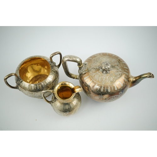 153 - A Victorian silver three piece tea set by John & Joseph Angell, of circular form with engraved decor... 