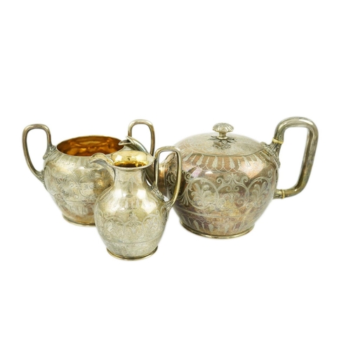 153 - A Victorian silver three piece tea set by John & Joseph Angell, of circular form with engraved decor... 