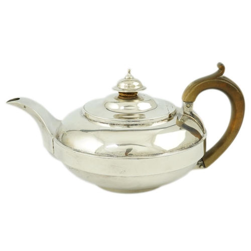 18 - A George III silver bachelor's teapot, by Eames & Barnard, of squat circular form, with engraved mon... 