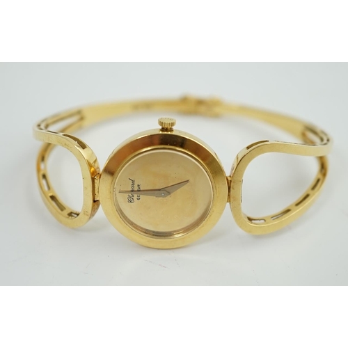 187 - A lady's 18k gold Swiss Chopard manual wind hinged bangle wrist watch, interior diameter 60mm, gross... 