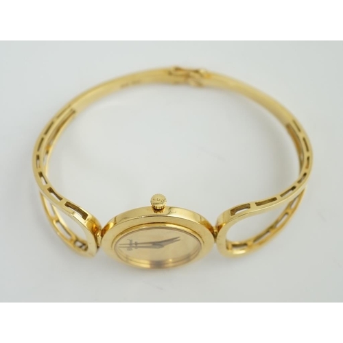 187 - A lady's 18k gold Swiss Chopard manual wind hinged bangle wrist watch, interior diameter 60mm, gross... 