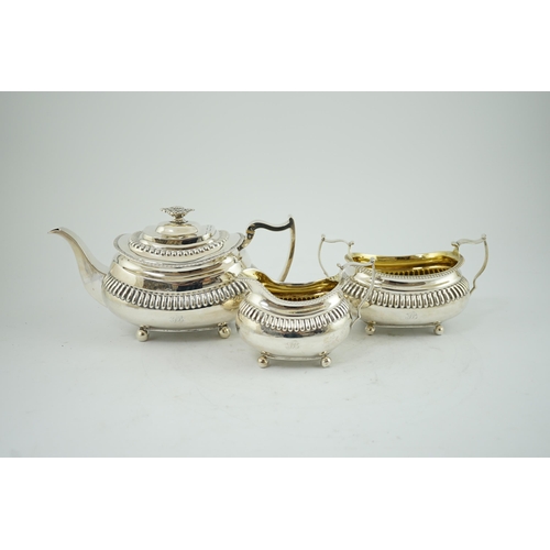 19A - A George III silver three piece tea set, by Soloman Hougham, of oval form, with fluted band, engrave... 