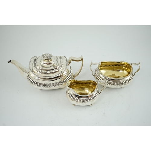 19A - A George III silver three piece tea set, by Soloman Hougham, of oval form, with fluted band, engrave... 