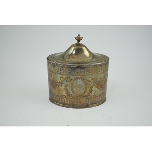 21 - A George III silver oval tea caddy by Hester Bateman, with engraved decoration and armorial and turn... 