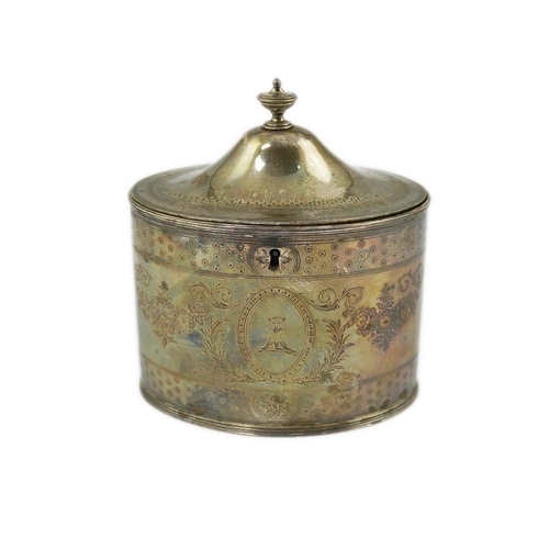 21 - A George III silver oval tea caddy by Hester Bateman, with engraved decoration and armorial and turn... 