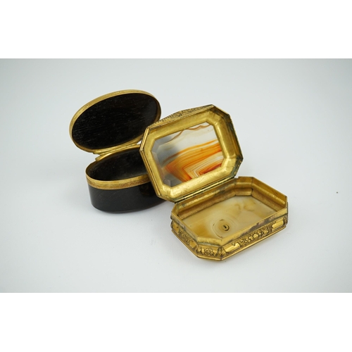 27 - An early 19th century German gold mounted rutile agate? oval snuff box, 64mm and another gilt copper... 