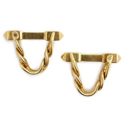 472 - A pair of 18K yellow gold stirrup cufflinks, by Boucheron, (signed and numbered 26504), of twisted c... 